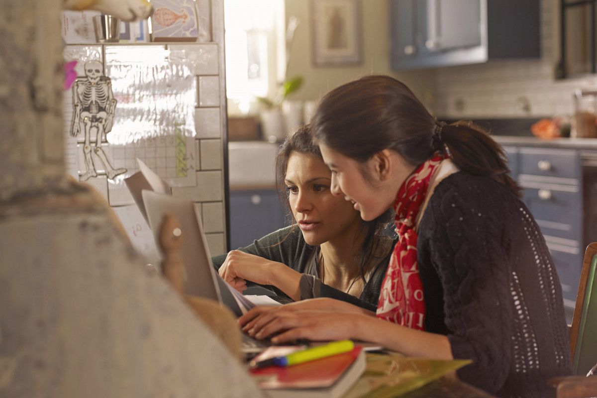 person standing on arrow sign on road