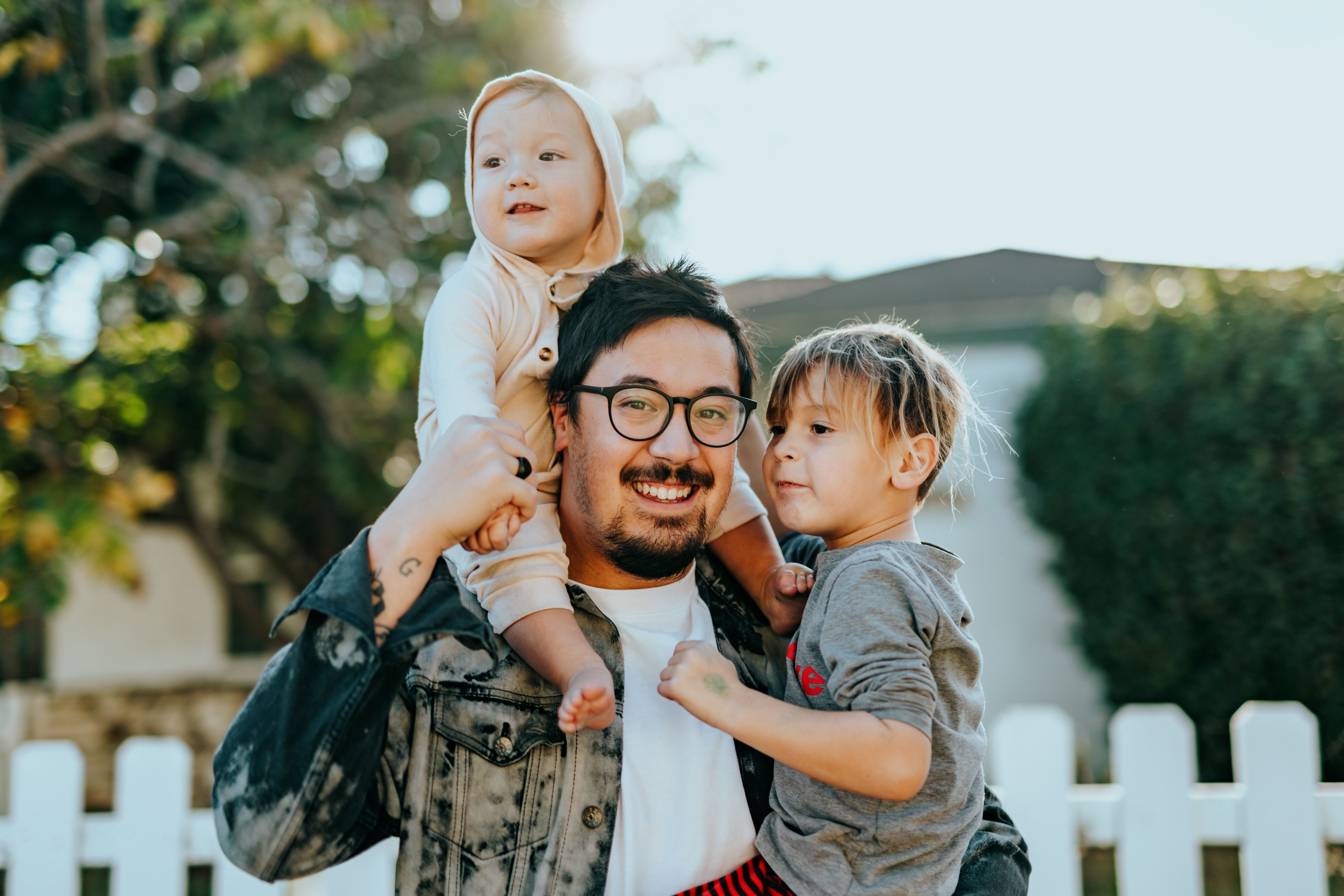 man in white shirt carrying girl in gray shirt  Photo by Nathan Dumlao on Unsplash